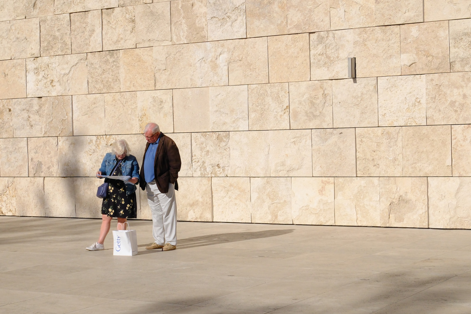 Older couple in front of wall