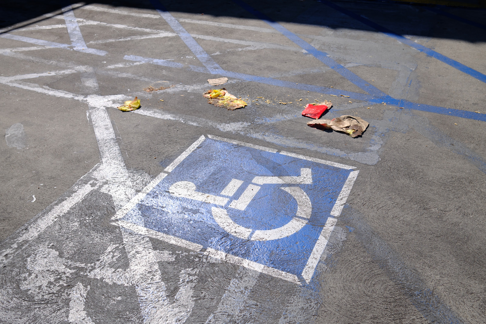 Trash in the middle of an accessibility parking spot